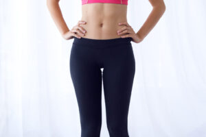 Young healthy girl on weight scales at home.